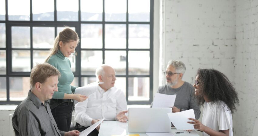 multiracial coworkers of different ages brainstorming together in office