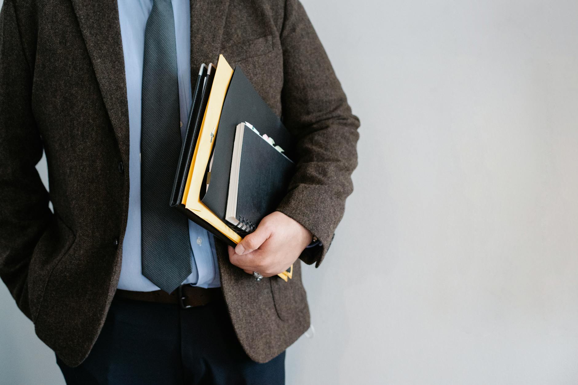 crop unrecognizable office worker standing with papers in hand