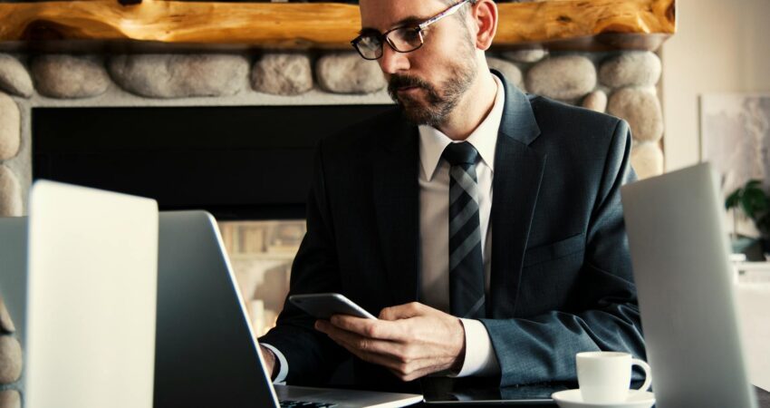 man in black holding phone