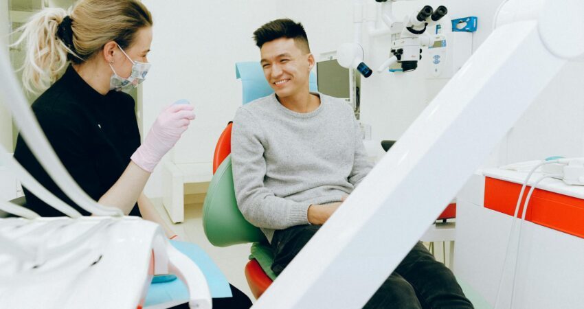 man sitting on dental chair