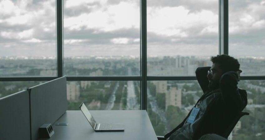 man reclining and looking at his laptop