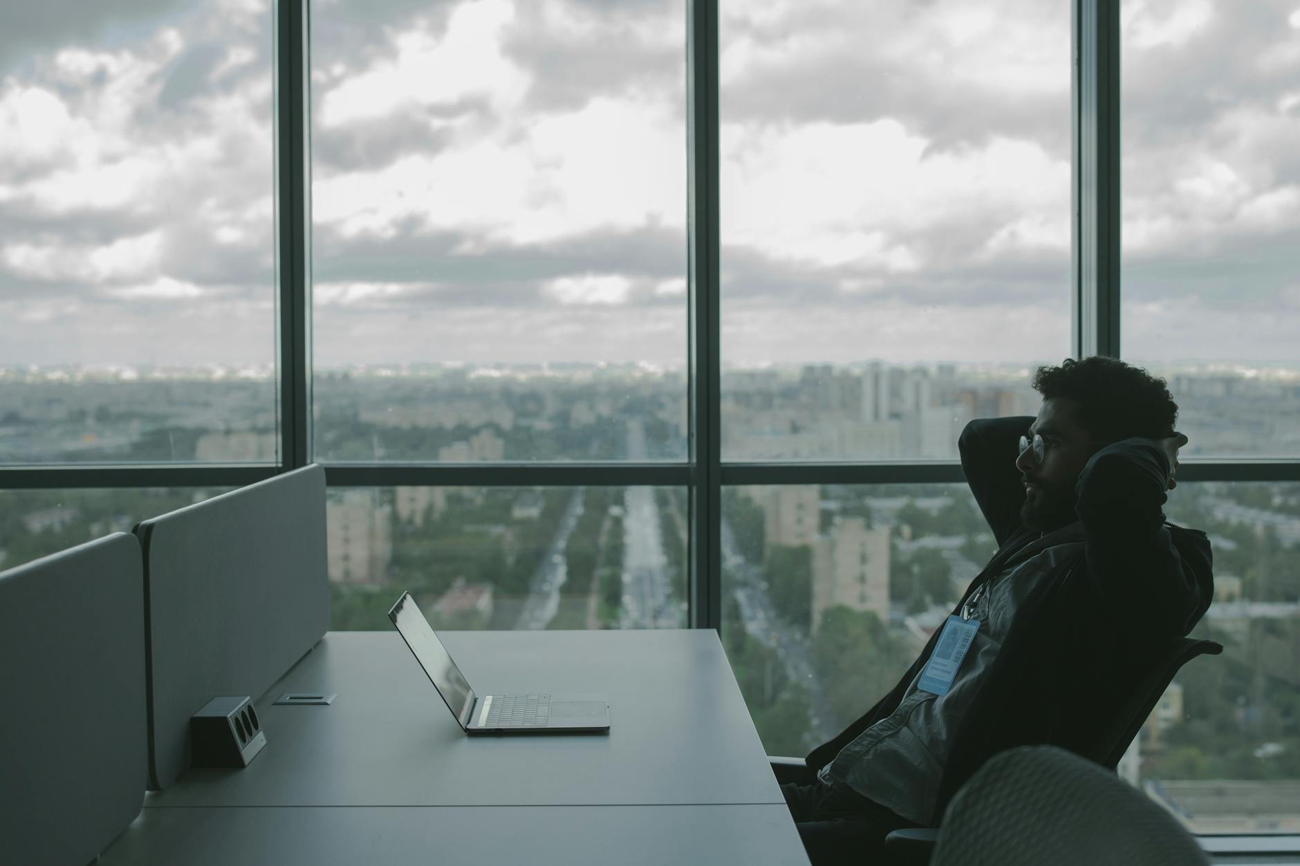 man reclining and looking at his laptop