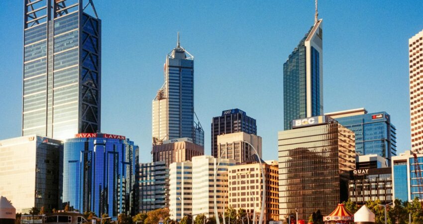 a city skyline with tall buildings and water