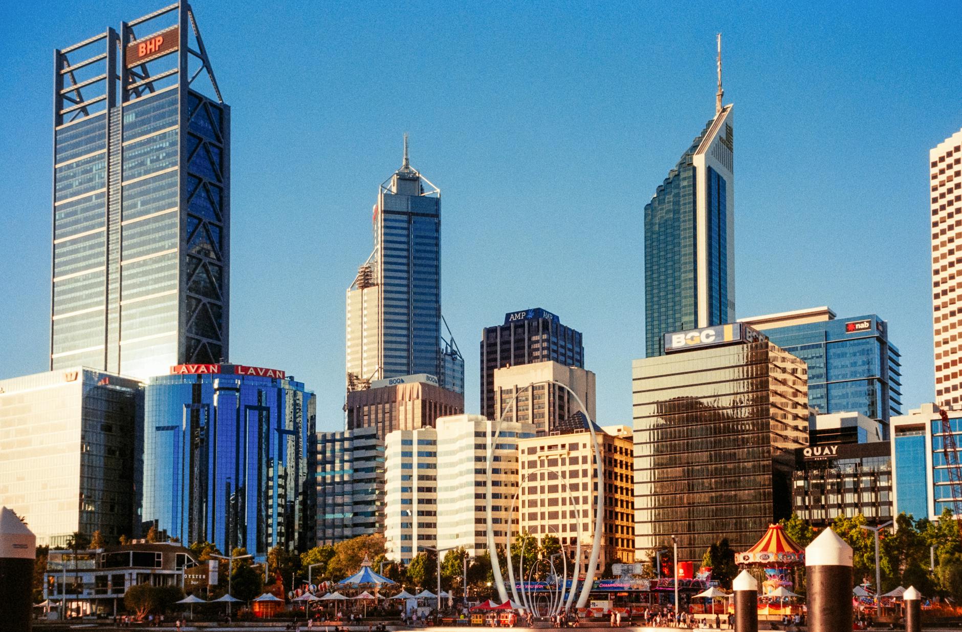 a city skyline with tall buildings and water