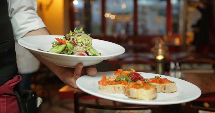 person holding pastry dishes on white ceramic plates