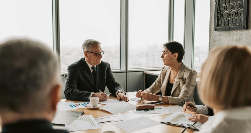 elderly man and woman discussing business in a meeting