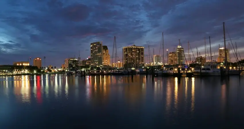 city skyline across body of water during night