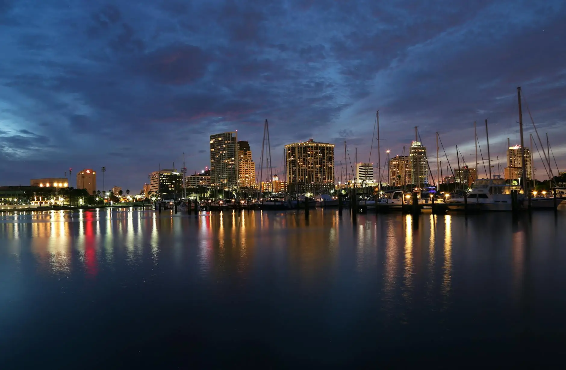 city skyline across body of water during night